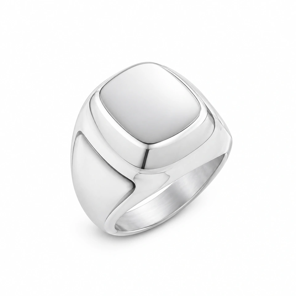 Anillo CMS-AN-1049, cabeza cuadrada redondeada compacta de metal liso, sin piedras, sobre fondo blanco.