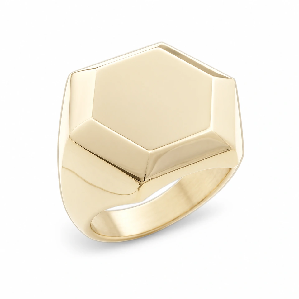 Anillo CMS-AN-1088 de apariencia dorada, cabeza hexagonal amplia de metal liso, sin piedras, sobre fondo blanco.